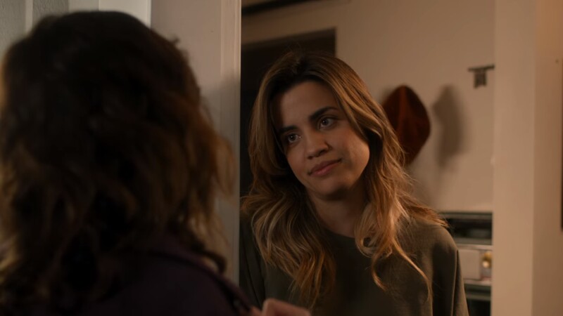 Natalie Morales rests on a doorframe