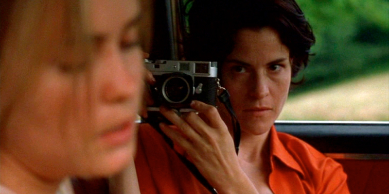 Ally Sheedy takes a picture of Radha Mitchell in a car.