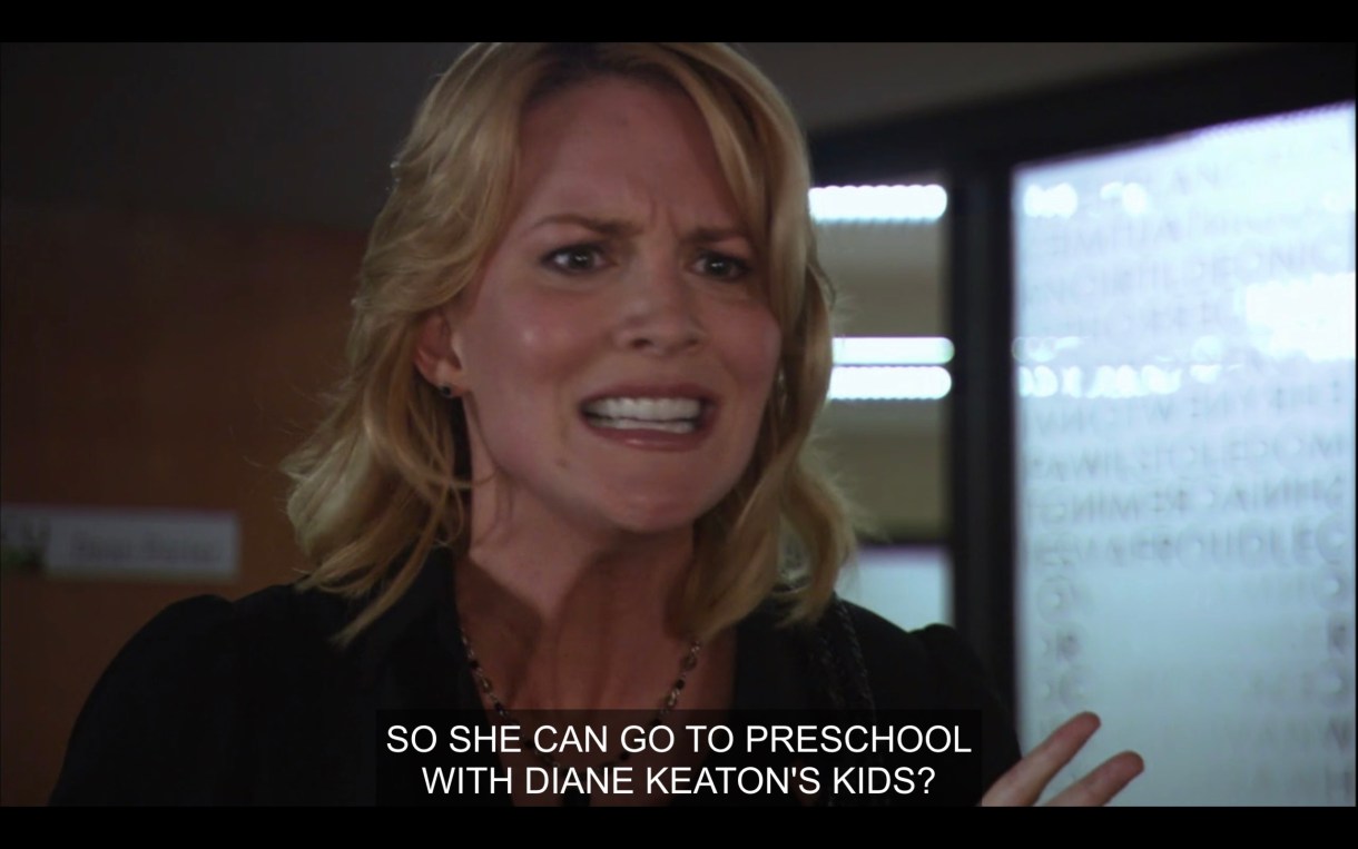 Tina looks angry and is standing in Bette's office. She says, "So she can go to preschool with Diane Keaton's kids?"