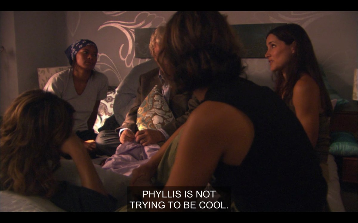 Alice, Tasha, and Helena sitting in Alice's bed. Helena says, "Phyllis is not trying to be cool."