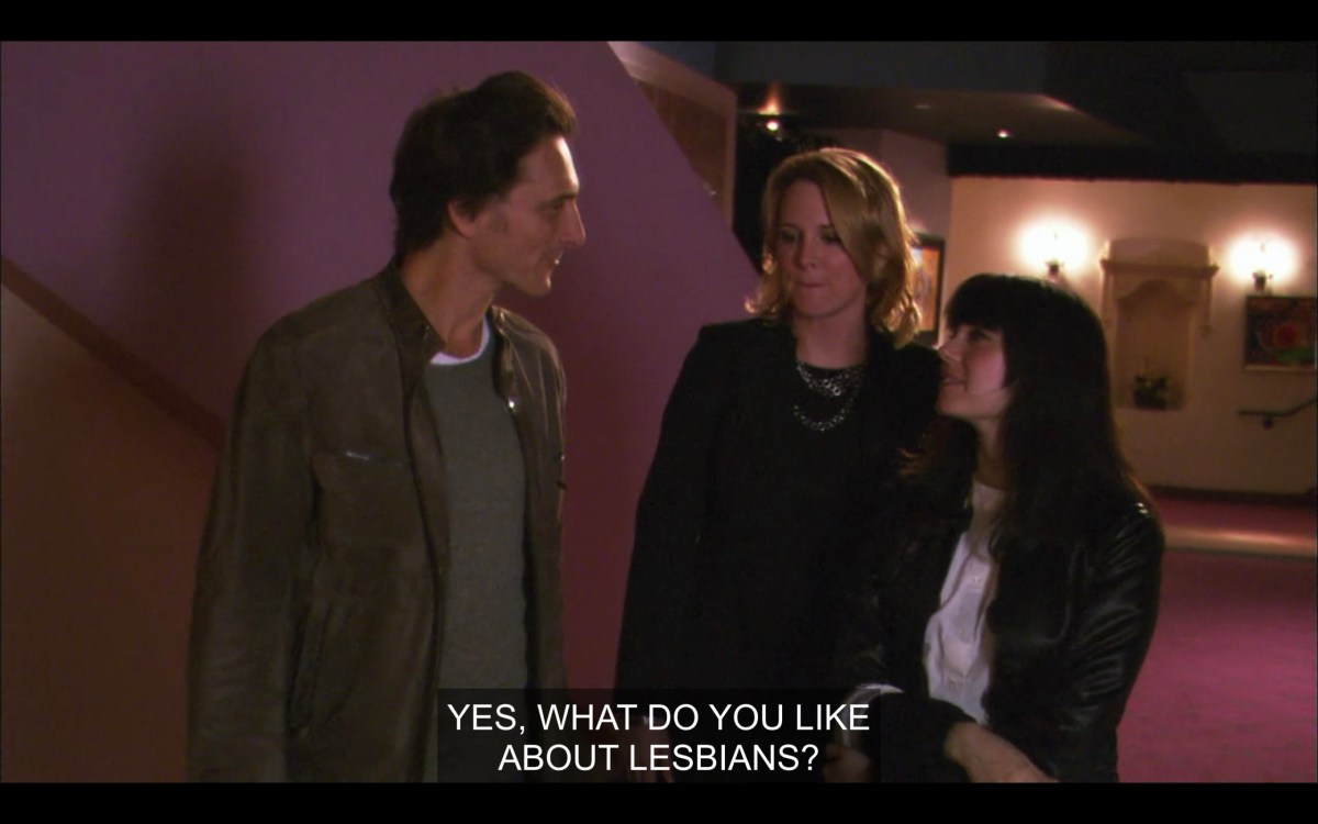 Tina and Jenny talking to a white guy with short brown hair. Jenny says, "Yes, what do you like about lesbians?"