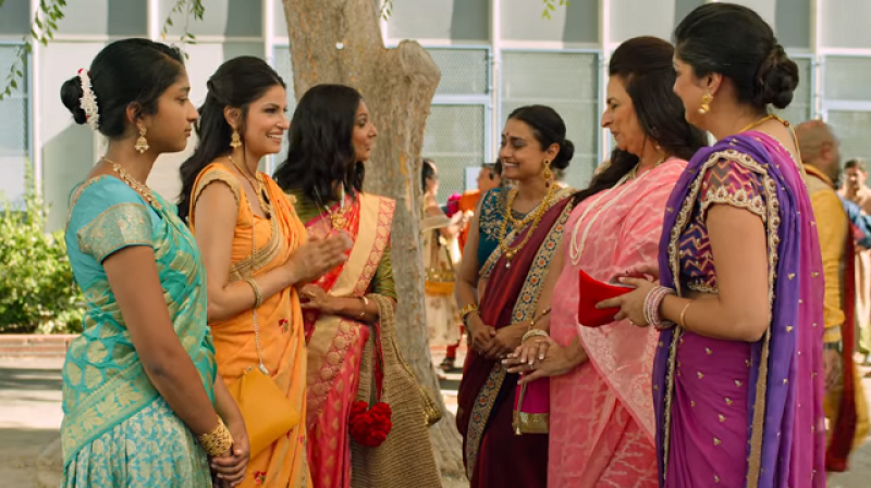 Devi, Kamala, and Nalini are met by three older Indian women at Ganesh puja.