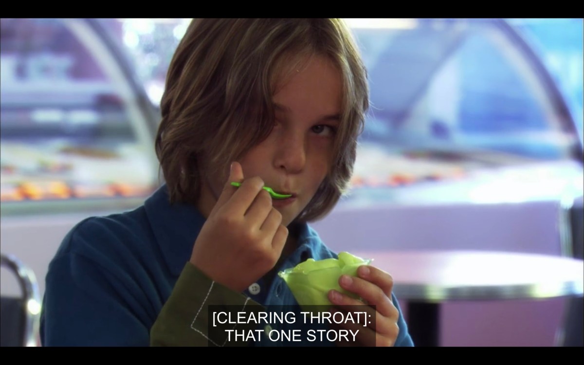 Jared is wearing a blue shirt and eating green ice cream with a green spoon. "[Clearing throat]: That one story"