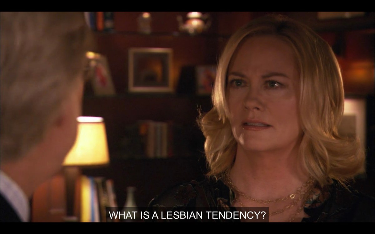 Phyllis stares back at her husband (whose back is to the camera) and says, "What is a lesbian tendency?"