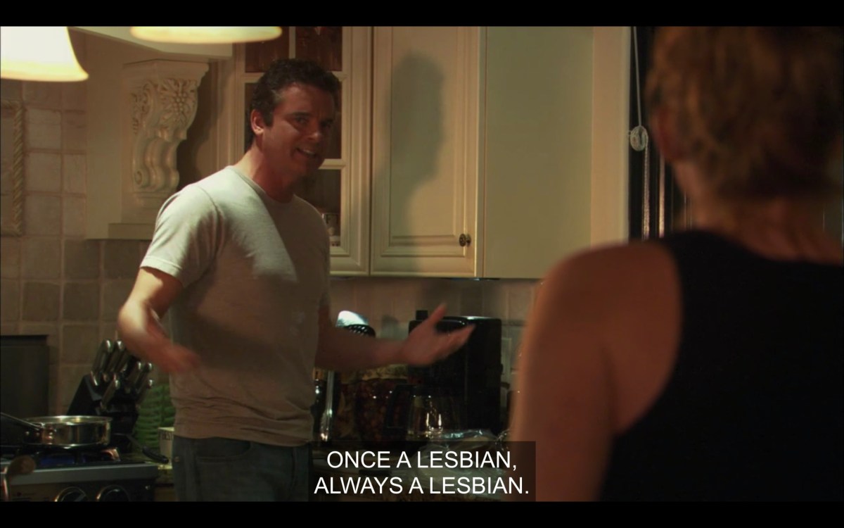 Henry and Tina (her back to the camera) standing in the kitchen. Henry says, "Once a lesbian, always a lesbian."