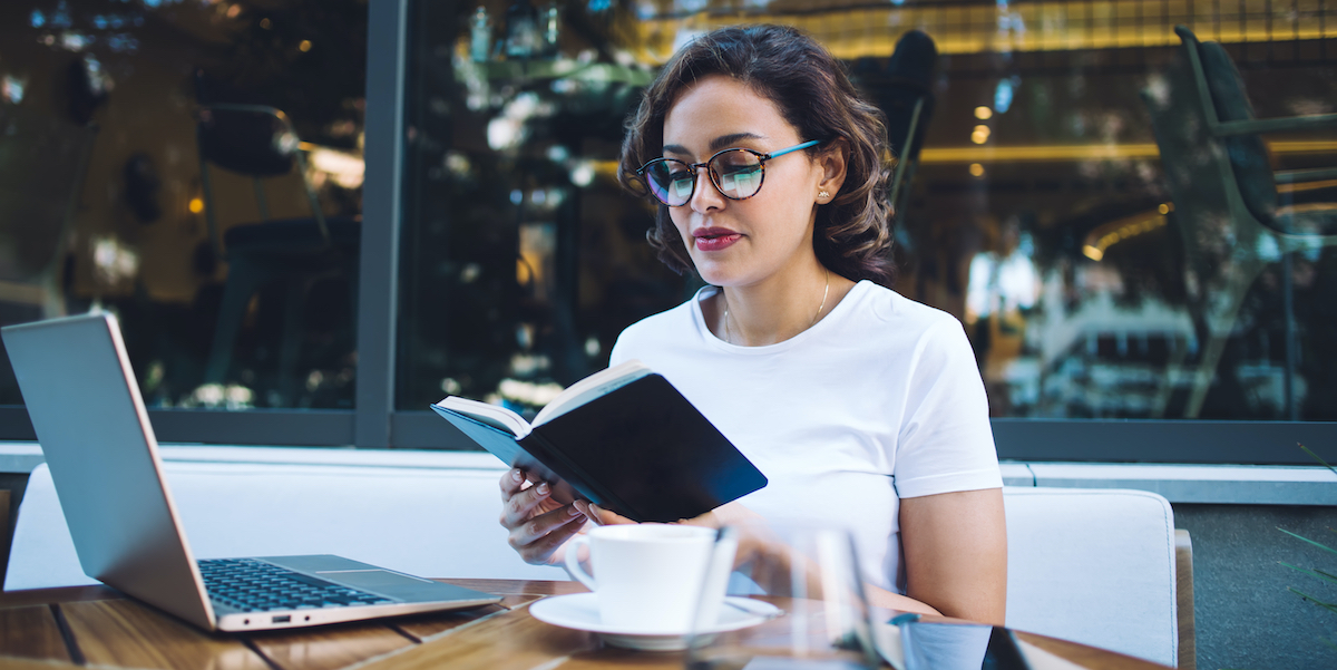 a woman reading outside