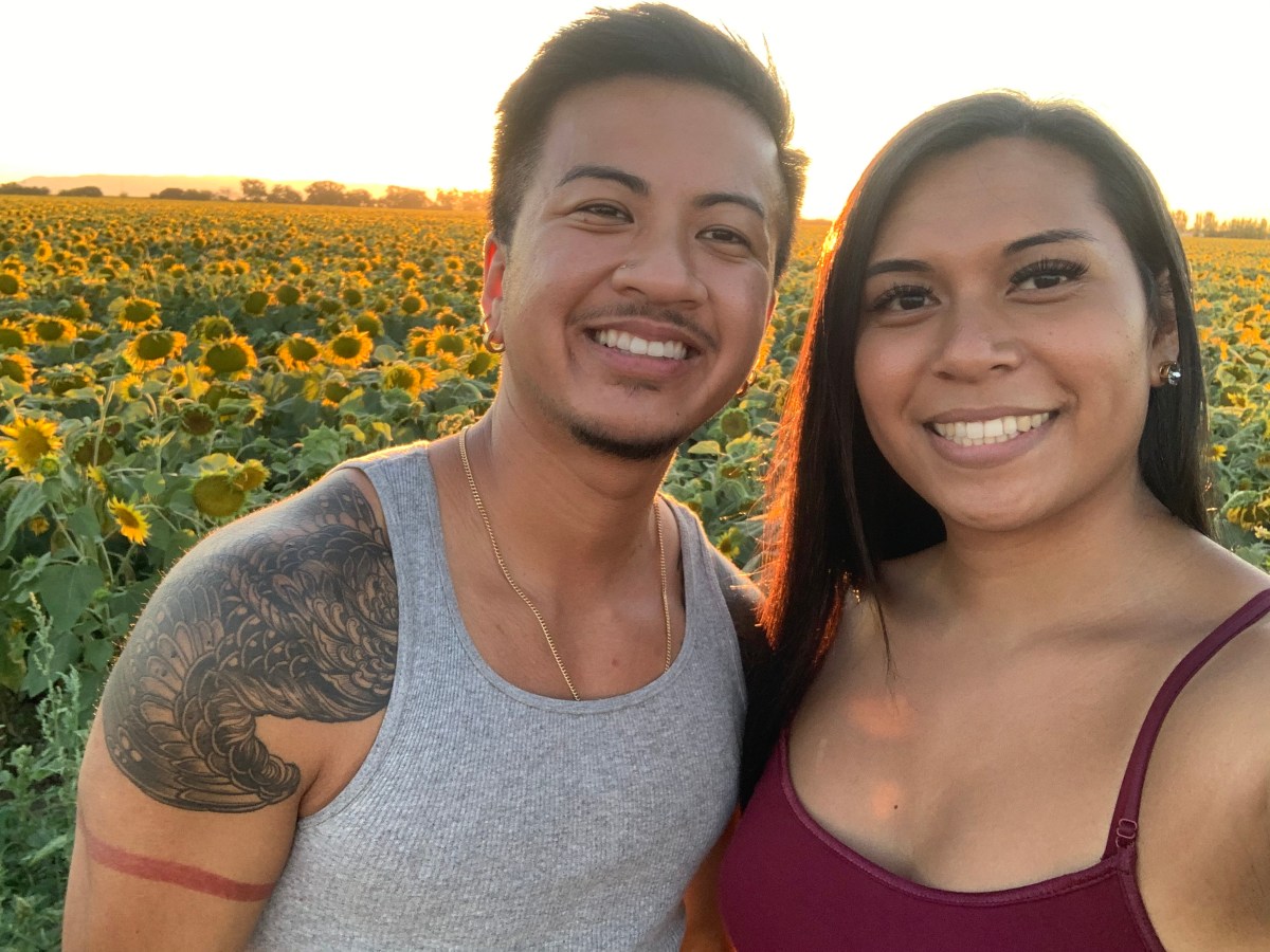 Lotus and Malaya standing among sunflowers.