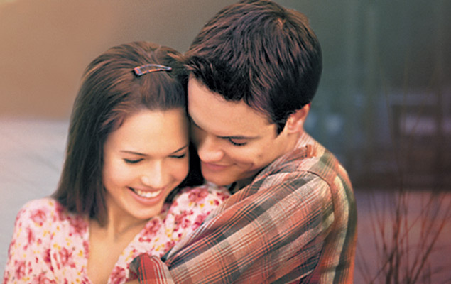 Mandy Moore and... a male actor?? wearing plaid embrace heterosexually