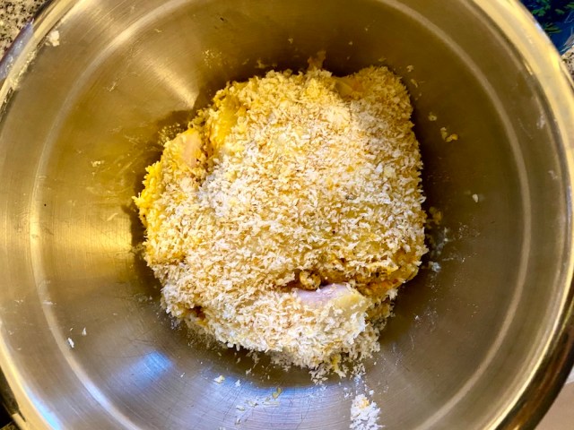 a floured, egg-washed, and panko-covered cornish game hen awaiting her fry