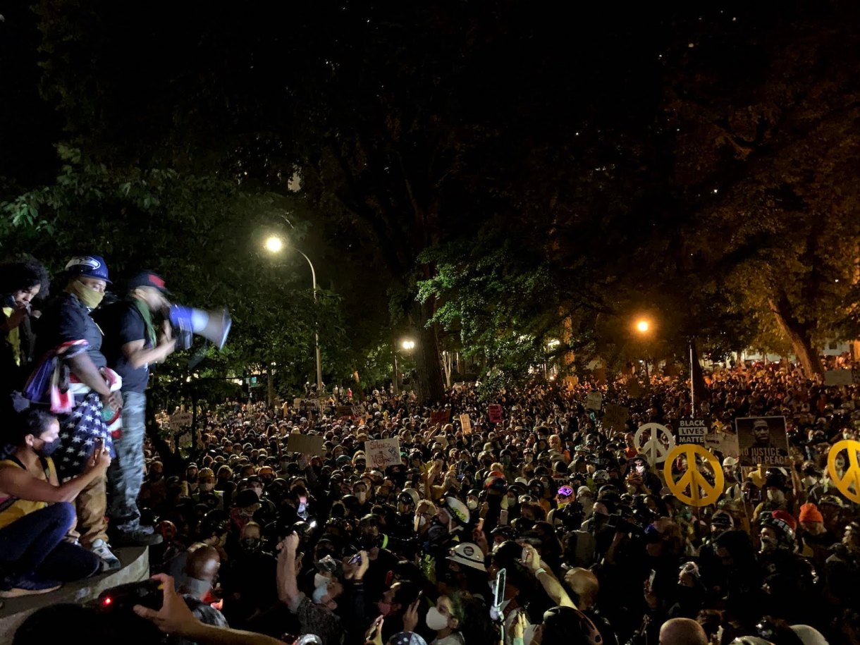 Activist and We Out Here founder Mac Smiff addresses thousands of protesters outside of the Portland Police Bureau headquarters on July 22.