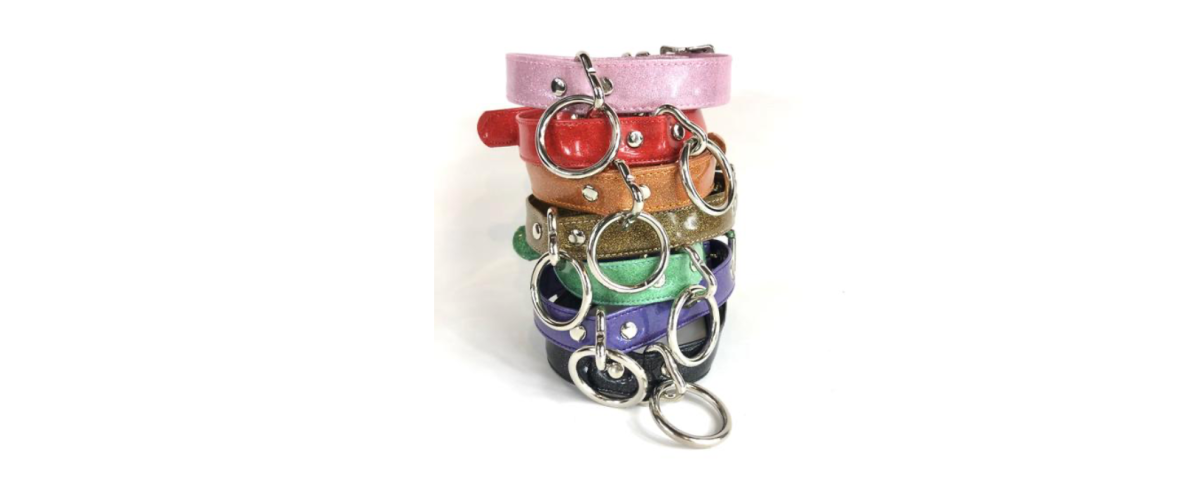 a stack of sparkly colorful vinyl collars with silver-colored hardware