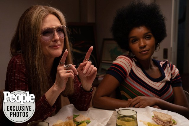 Janelle Monae in an Afro as Dorothy Height sits at a table with Julianne More as Gloria Steinem, set in the 1970s from the upcoming film "The Glorias."