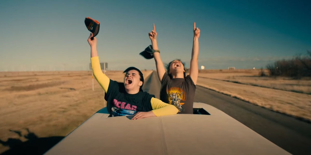 two girls screaming out the top of a car on a desert highway, from "Unpregnant"