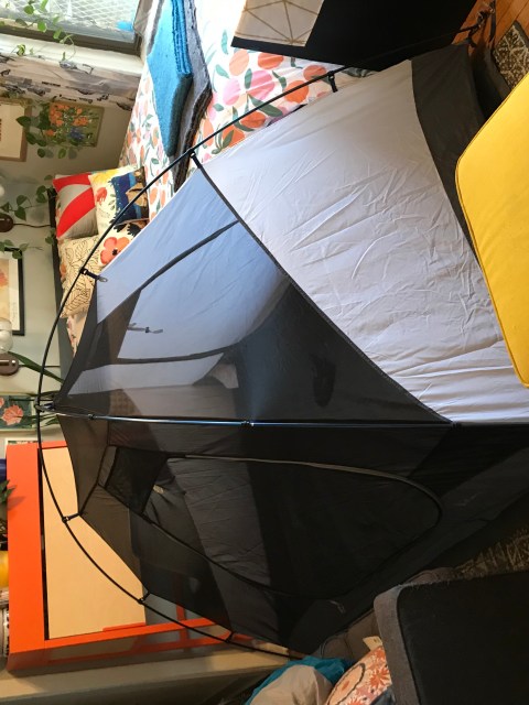 A tent constructed in a cramped living room.