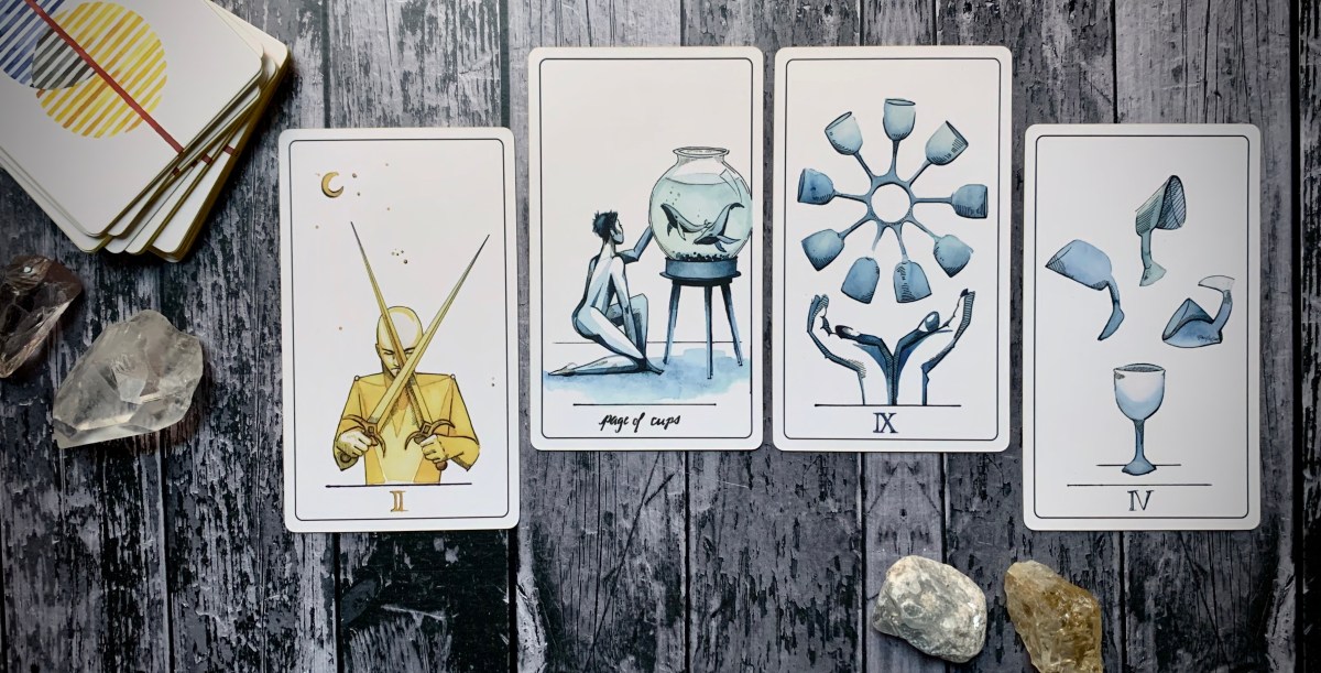 From left to right, cards drawn are: The 2 of swords, page of cups, 9 of cups, and 4 of cups