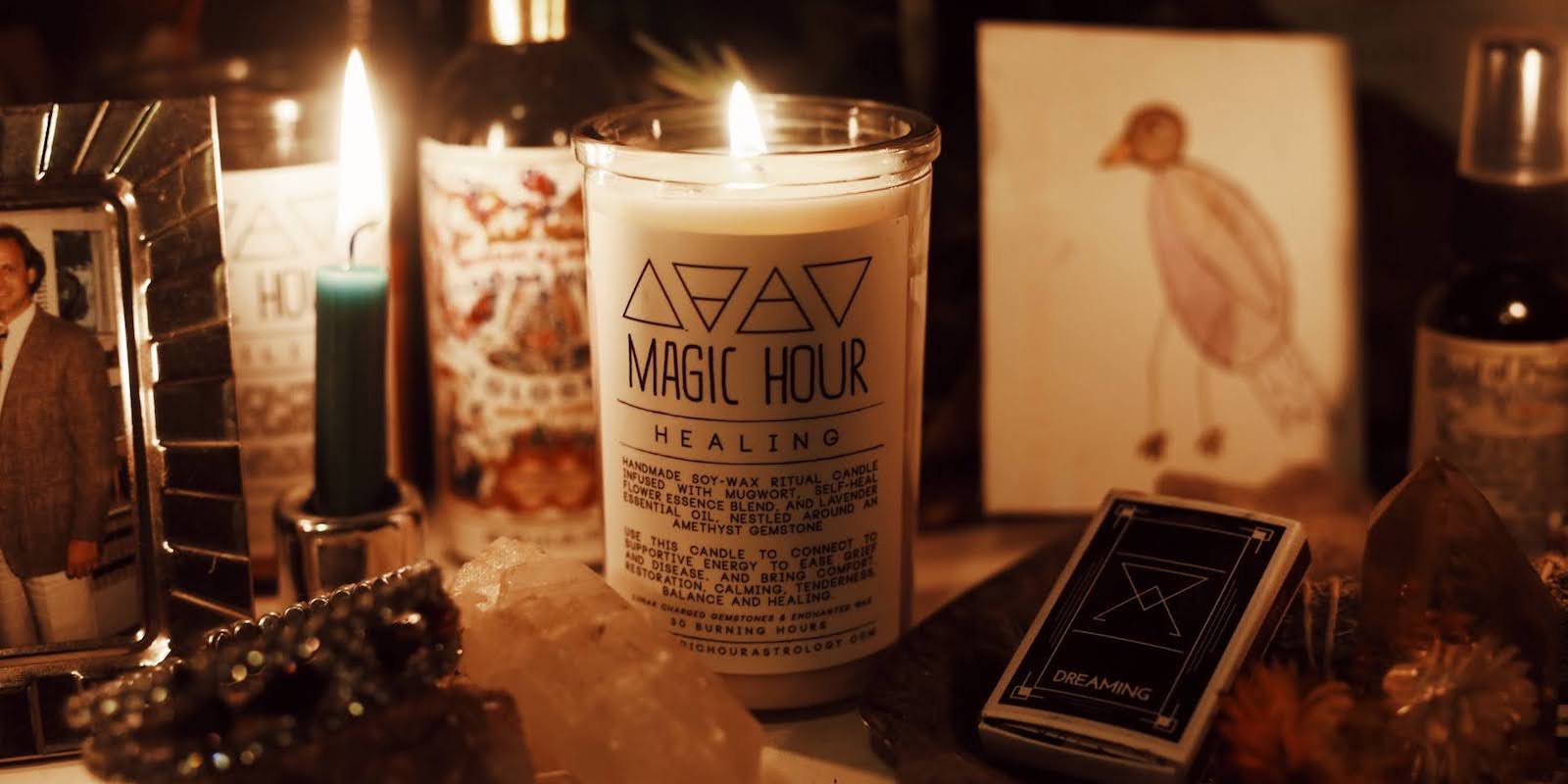 a collection of objects on an altar: a candle for healing, a framed photo, a hand-drawn picture of a little bird