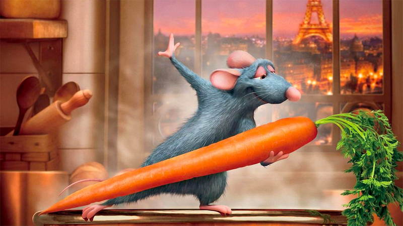 Remy dances with a carrot in front of a window with the Eiffel Tower in the background. 