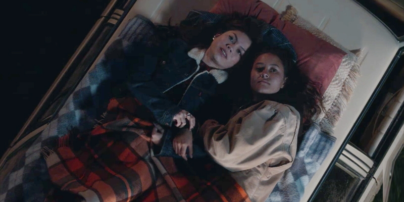 Toni and her girlfriend snuggle in the back of a truck on The Wilds.