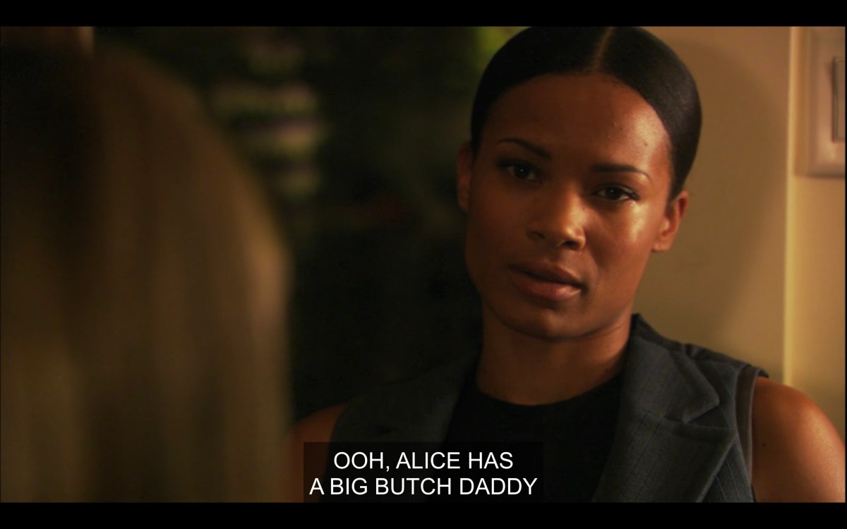 Tasha looking at Papi and Gaby with despair as Gaby calls her Alice's "big butch daddy"