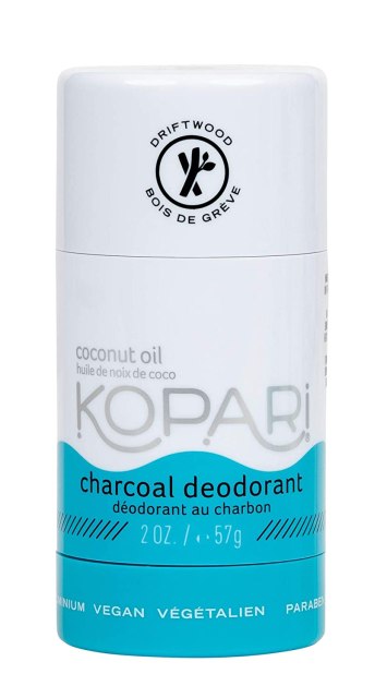 A cylindrical white and blue deodorant stick reads, "Kopari: charcoal deodorant"