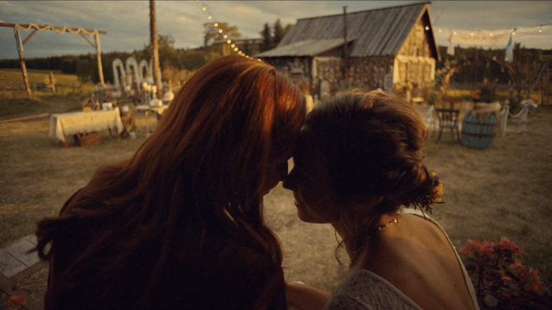 Waverly and Nicole press their foreheads together on the front porch of their forever home.