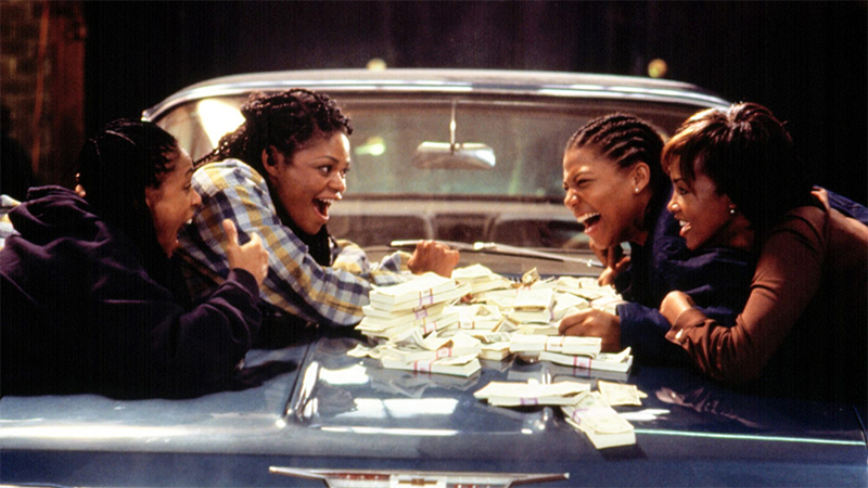 The women of Set It Off count their money on the hood of a classic car