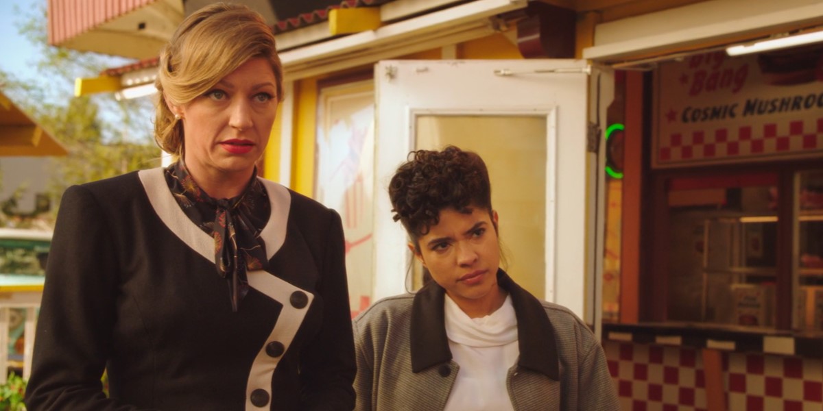 Still from Legends of Tomorrow: Ava Sharpe and Spooner are dressed as a 50s airline attendant and a 50s greaser, respectively.