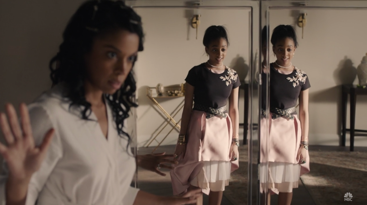 Tess Pearson tries on her bridesmaid outfit — a pink tulle skirt and black t-shirt — while her mother, Beth, looks on.