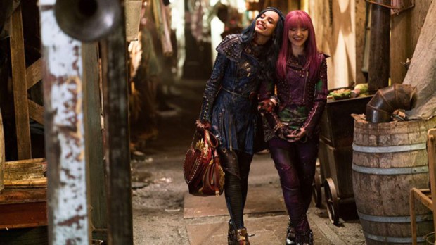Bisexual Dove Cameron as Mal from Descendants. She is walking while holding hands with Evie, played by Sofia Carson.