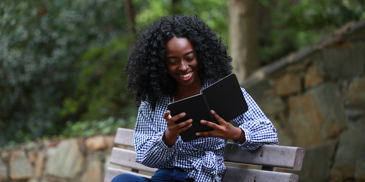 a woman reading outside