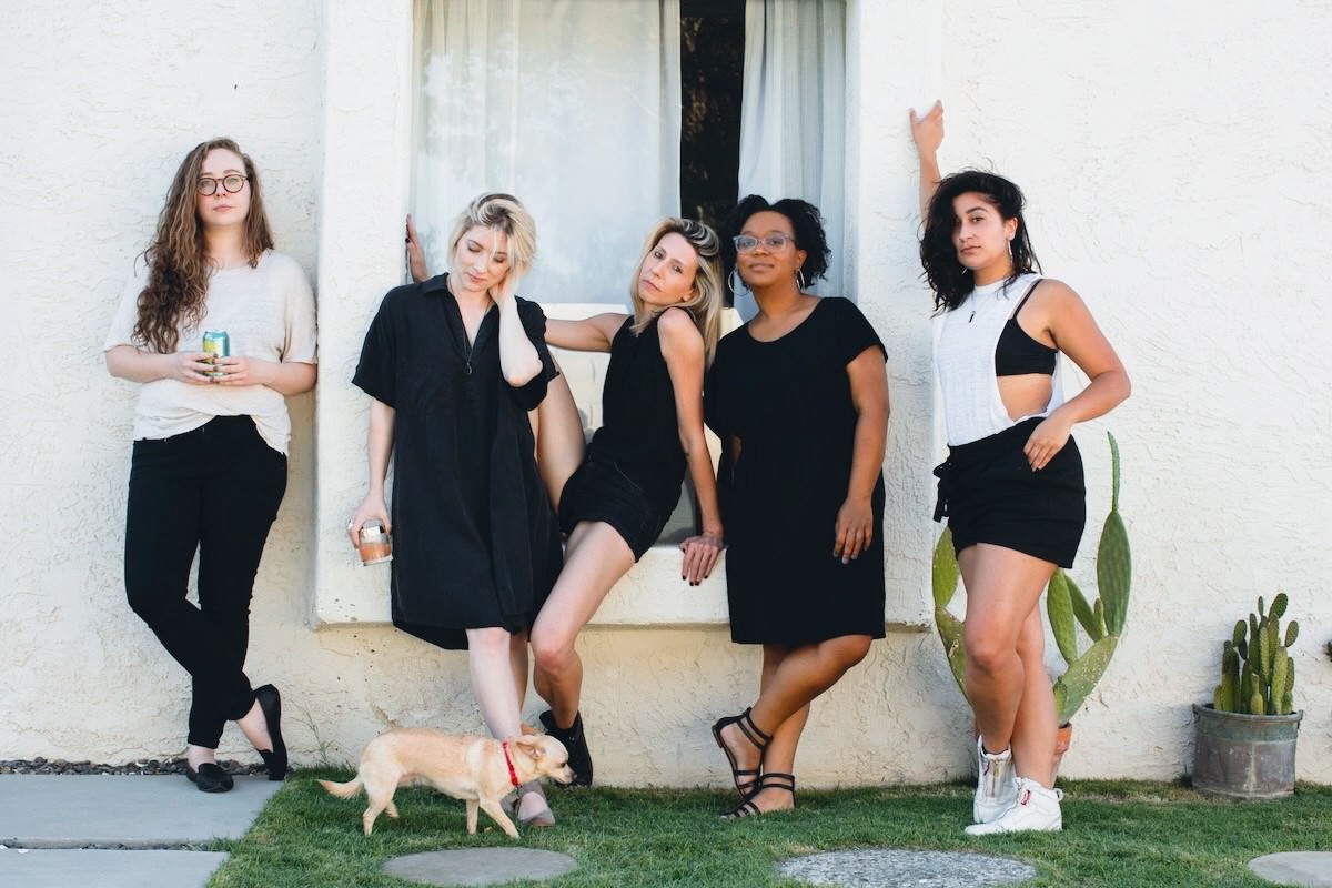 AS Senior Editors against a wall Rachel, Laneia, Riese, Carmen and Sarah. Also Carol the dog.
