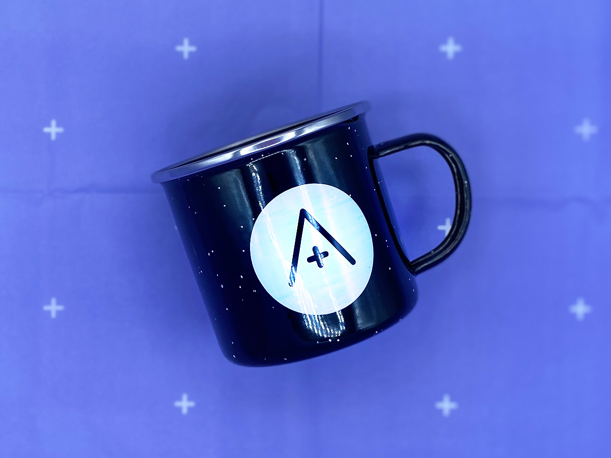 the a+ mug on a lilac background.