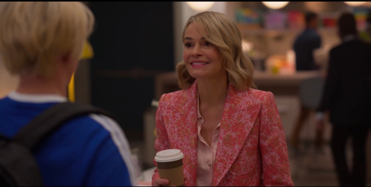 Alice in her office holding coffee