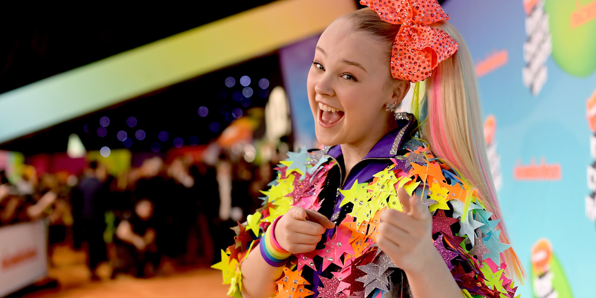 Jojo Siwa pointing at the camera and laughing