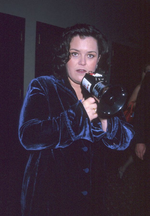 Rosie in a velvet blazer and a loudspeaker