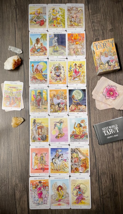 The major arcana cards laid out again, this time in seven lines of three cards each. Again, the Fool is set to the side along with crystals and the box for the Next World Tarot.