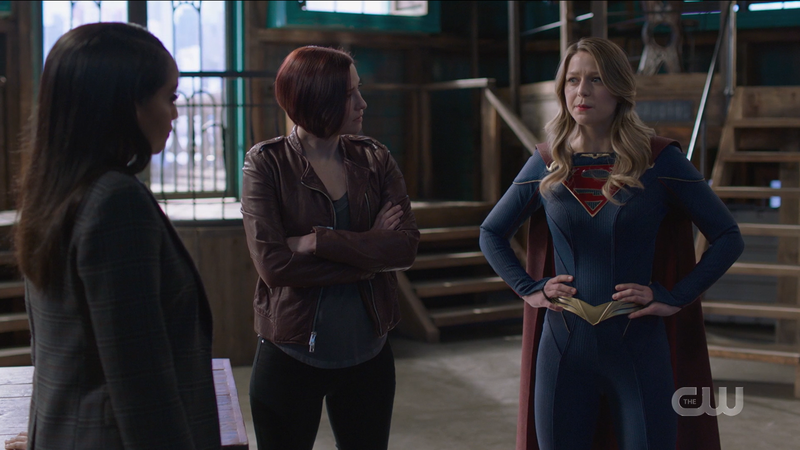 Supergirl 609: Alex stands with her arms crossed, Supergirl stands with her hands on her hips