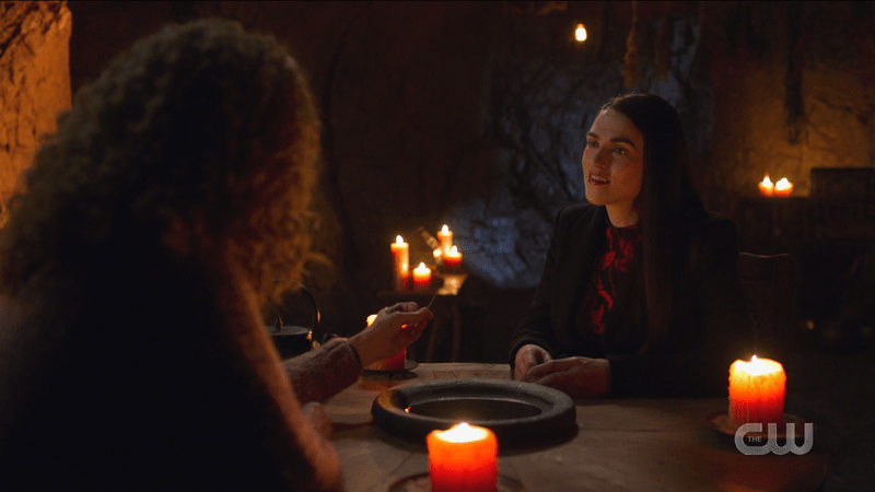 Lena looks skeptical at the magic table