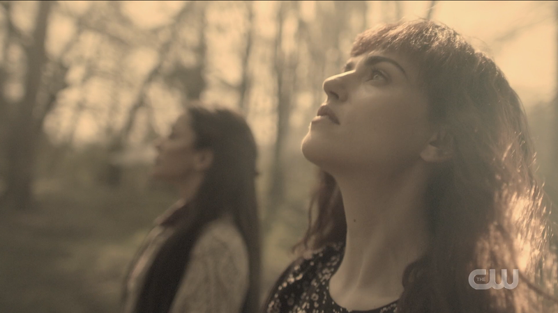 Elizabeth and Margaret look up to the sky and commune with nature in their bad CW wigs