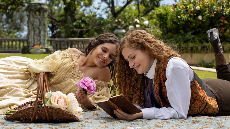 Rachel and Isabel read together on the lawn