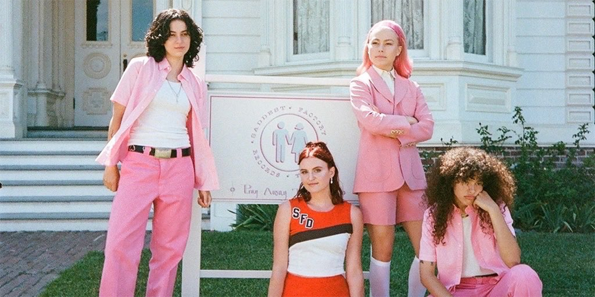 The band MUNA recreates a scene from But I'm a Cheerleader in all pink