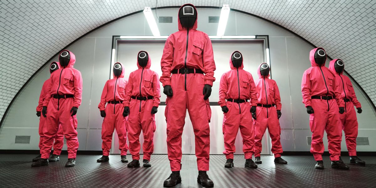 The Squid Game enforcers in red Hazmat suits