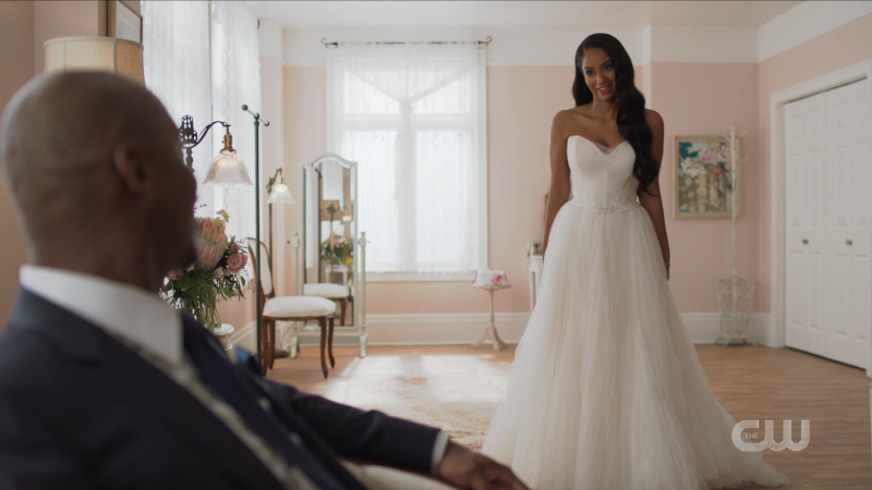 Kelly stands in her wedding gown looking stunning