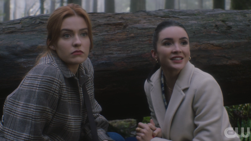 Bess and Nancy look like adorable liars as they crouch in a forest