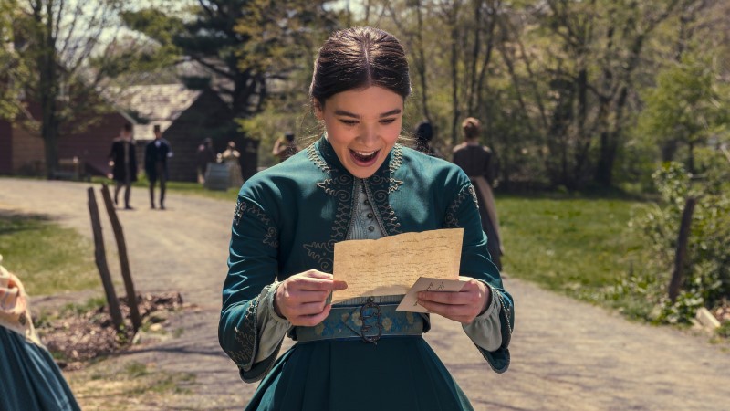 Hailee Steinfeld's Emily Dickinson beams at a piece of papereans