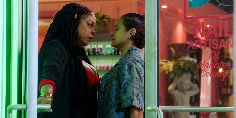 Desna and Ann stare each other down at the door to the Nail Artisans salon.