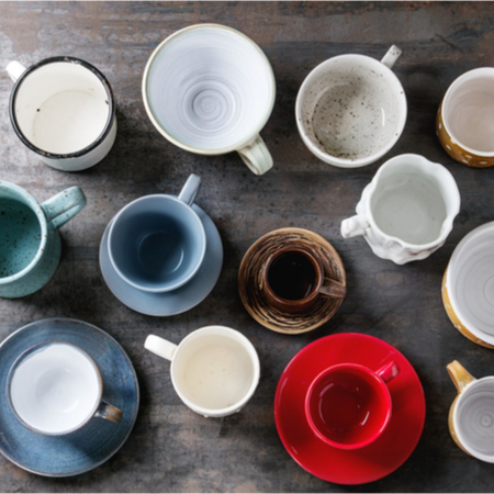 An overhead image of mugs in various sizes and colors