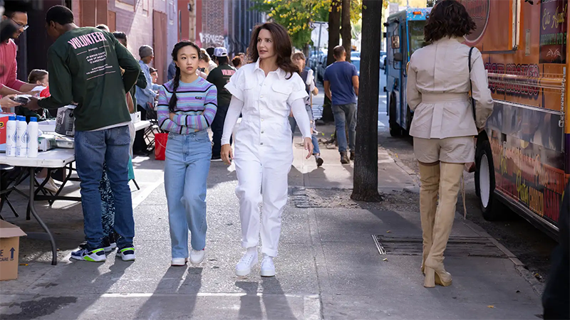 Lily and Charlotte walk down the sidewalk