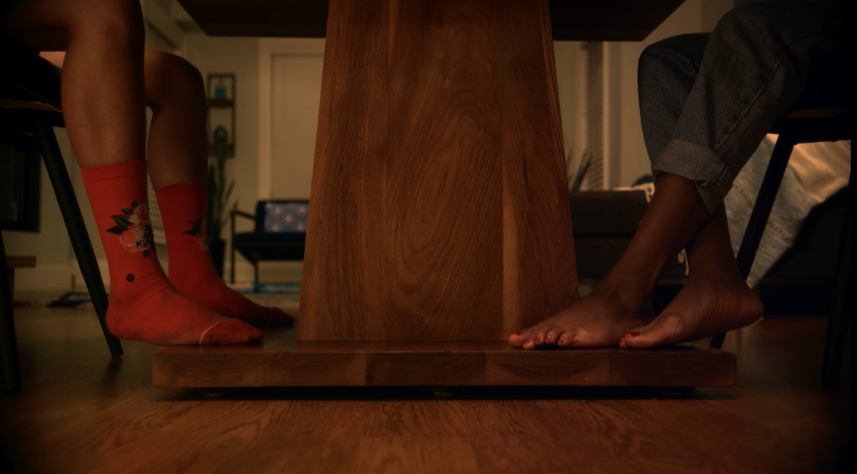 Noor and Layla sit at a table on their first date, all we see is a shot of their feet (with no shoes on) under the table. Queer muslim love