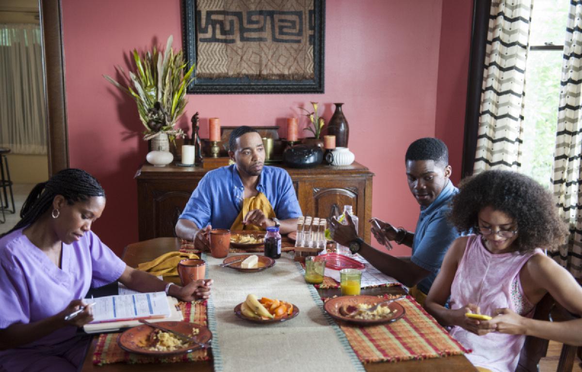 The leftovers still: Jasmin Savoy-brown is amongst those seated at the dinner table in a still from The Leftovers